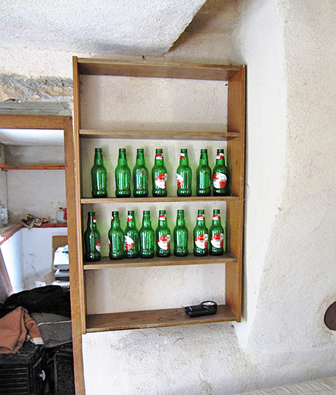Een kastje met lege flesjes bier erin, in het Geheime Landhuis.